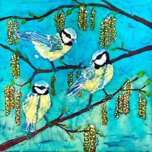 Depiction of three blue tits on hazel branches with hanging catkins.